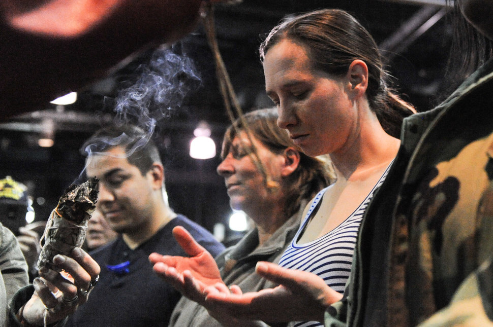 Veterans receive a blessing of sage during a healing ceremony hosted by the Standing Rock Sioux tribe as "water protectors" continue to demonstrate against plans to pass the Dakota Access pipeline near the Standing Rock Indian Reservation, in Fort Yates, North Dakota, U.S. December 5, 2016. REUTERS/Stephanie Keith