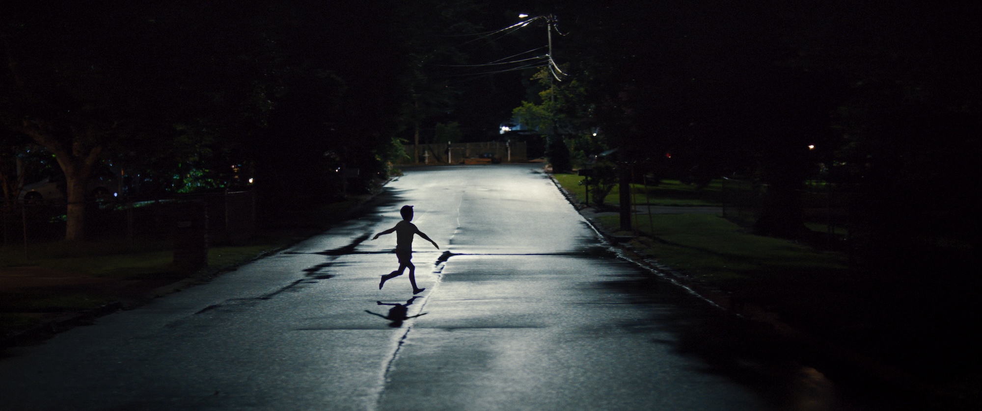 A child runs down the street in the middle of the night in a scene from New Line Cinema’s “Weapons,” a Warner Bros. Pictures release.