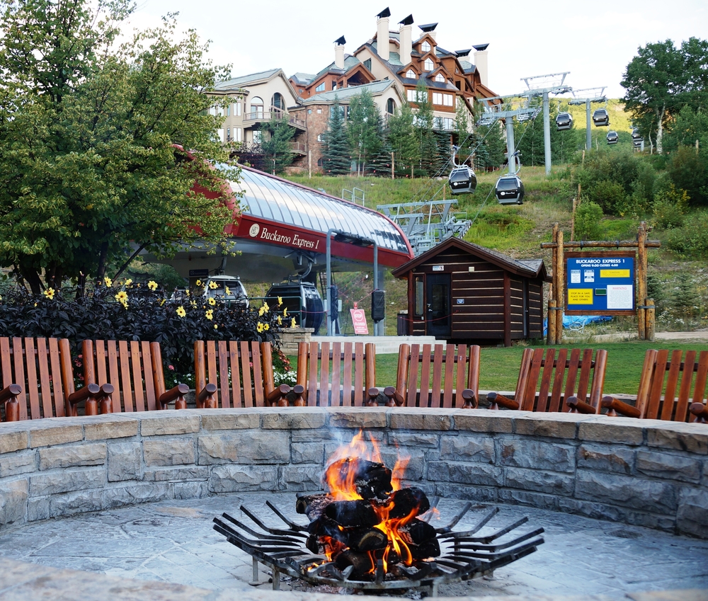 Smoking bonfire with resort in the background.