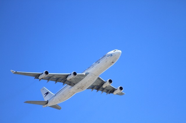 a plane in the air in a blue sky