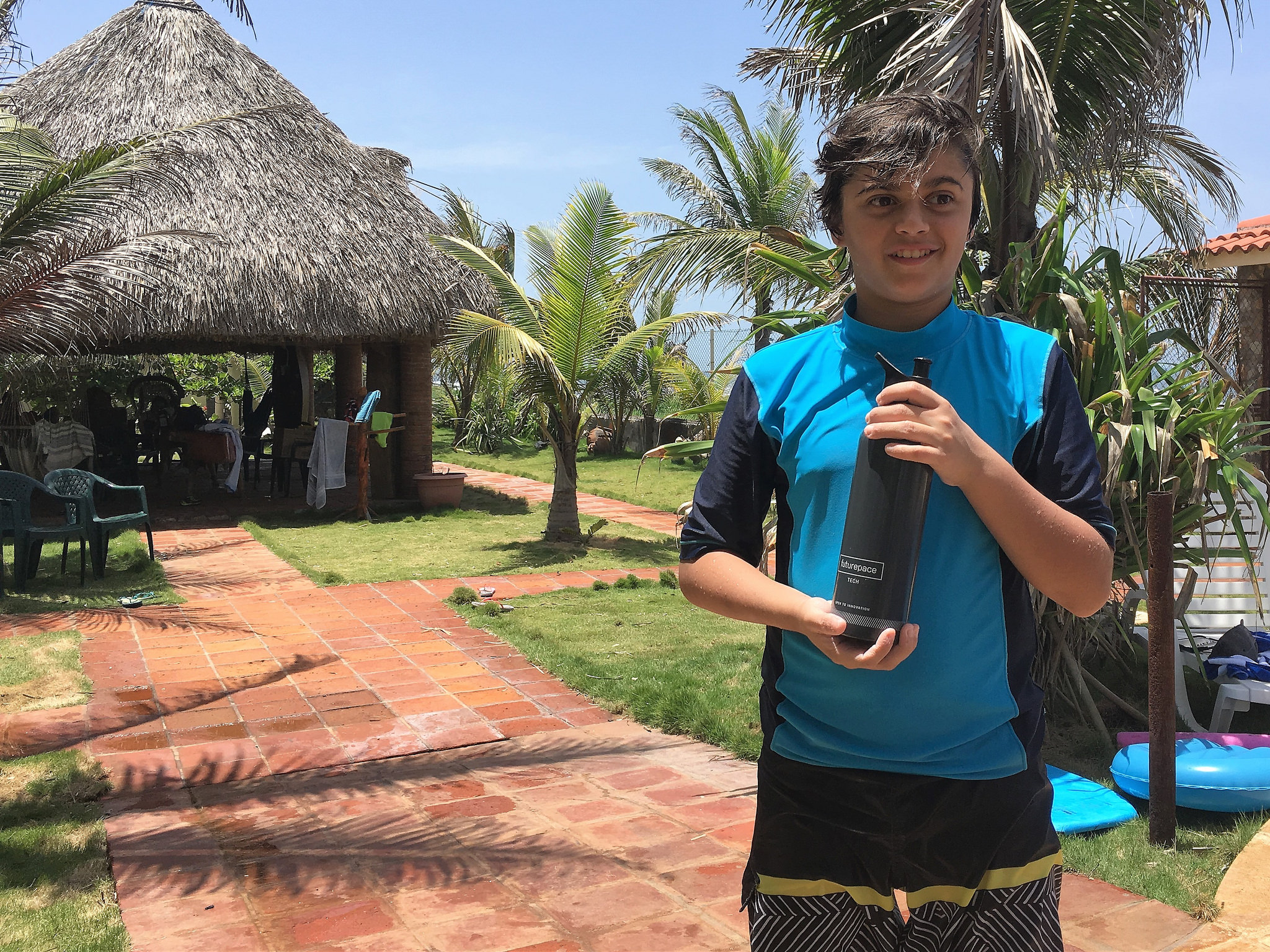 A kid holding a FuturePace Tech water bottle