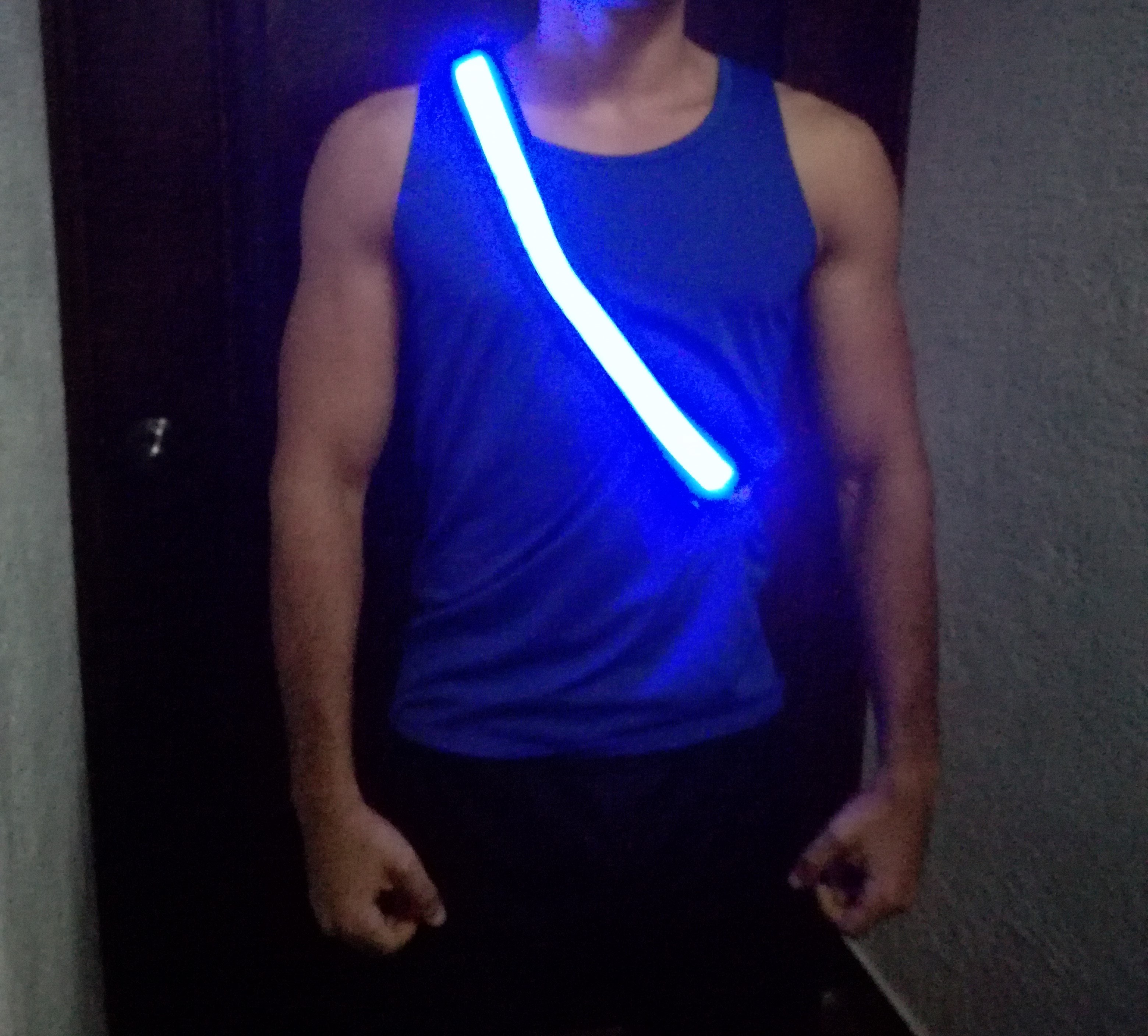 man wearing a blue tank shirt with a led belt turned on