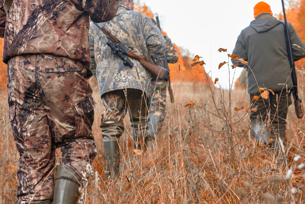 group of hunters during hunting in forest