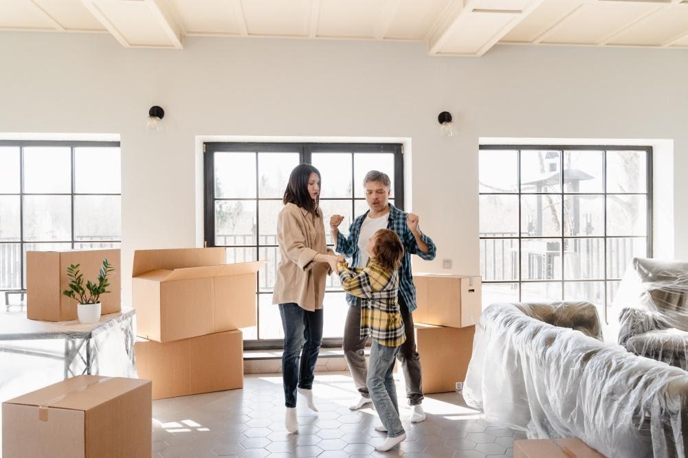 family of three packing everything to move