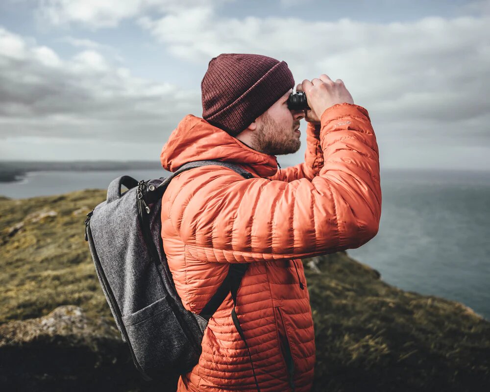 a guy using binoculars