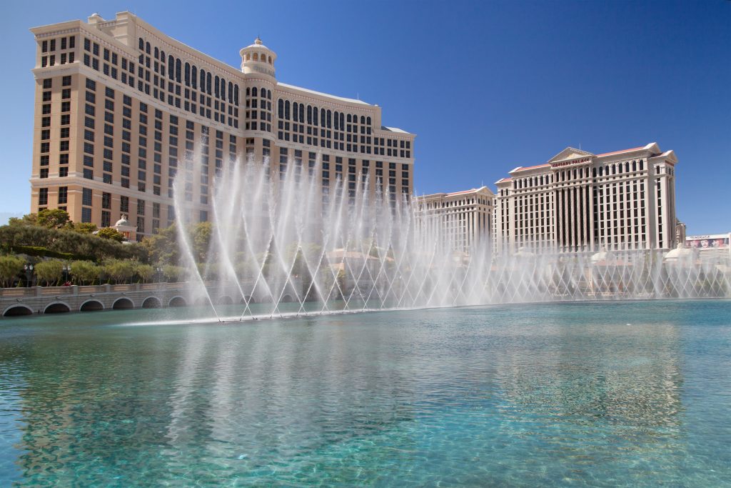 The Bellagio and nearby Caesars Palace, with the fountains of Bellagio in the foreground, Las Vegas, Nevada, United States.