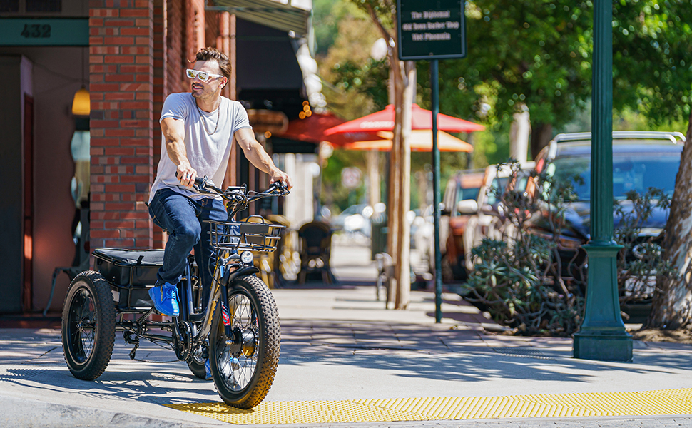 man with glasses riding a electric bike