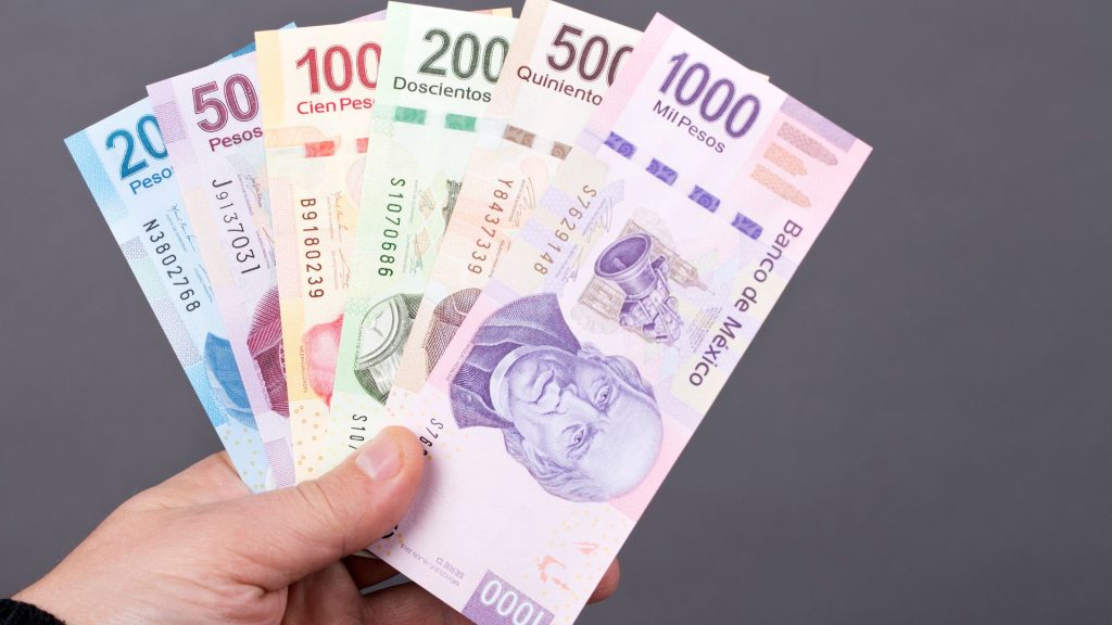 a person holding a pesos in mexico after exchange