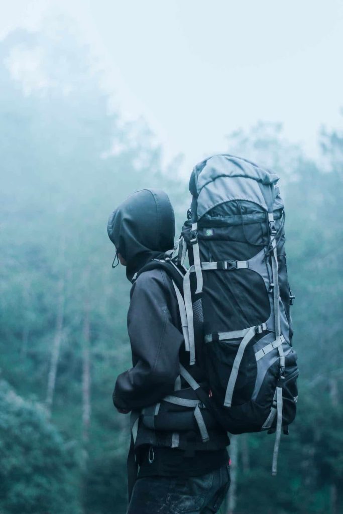 a man in the woods wearing a thule bag