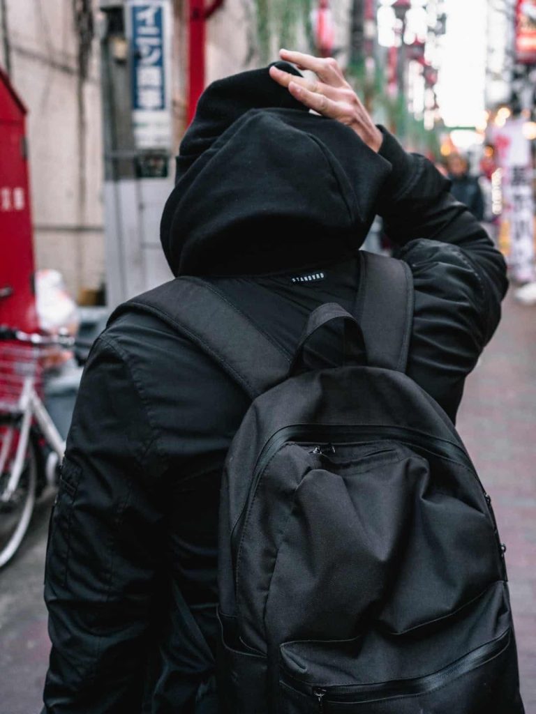 a man wearing a black thule bag 