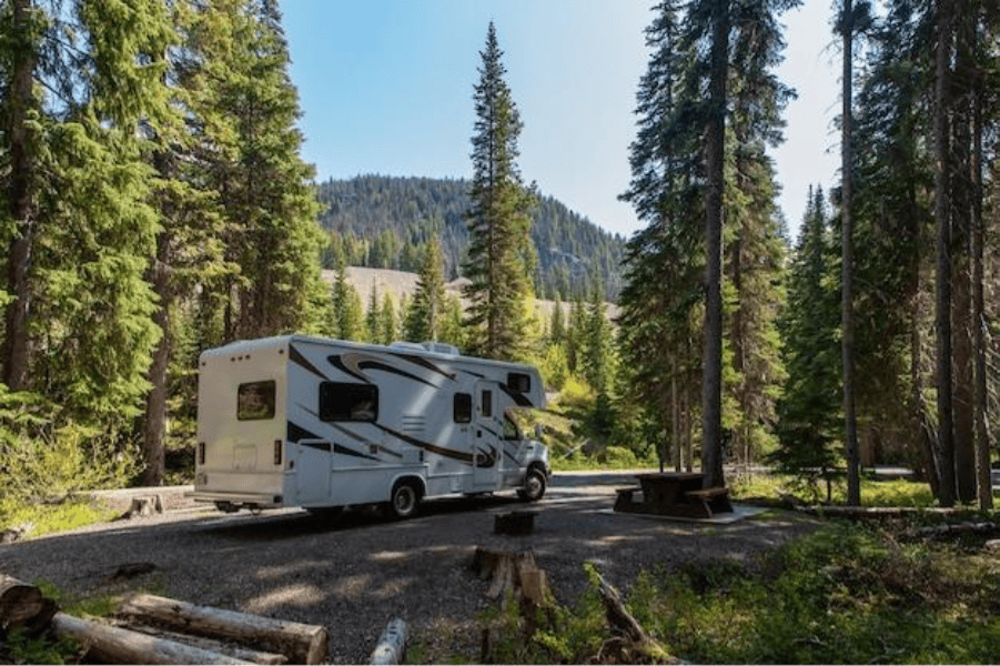 an RV parked at a campsite in a mountainous area