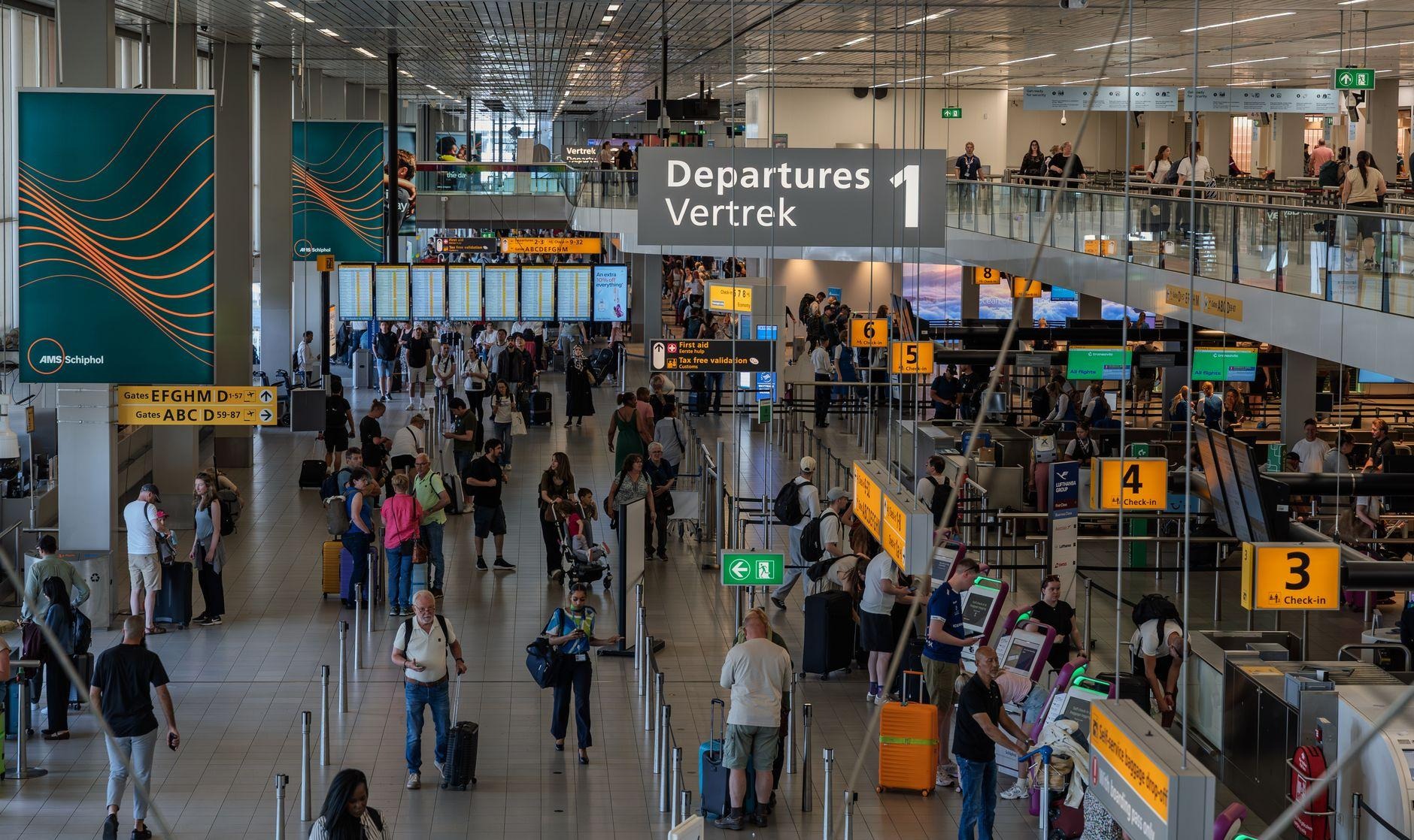 Crowds filling the departure hall at Amsterdam Schiphol Airport Crowds filling the departure hall at Amsterdam Schiphol Airport