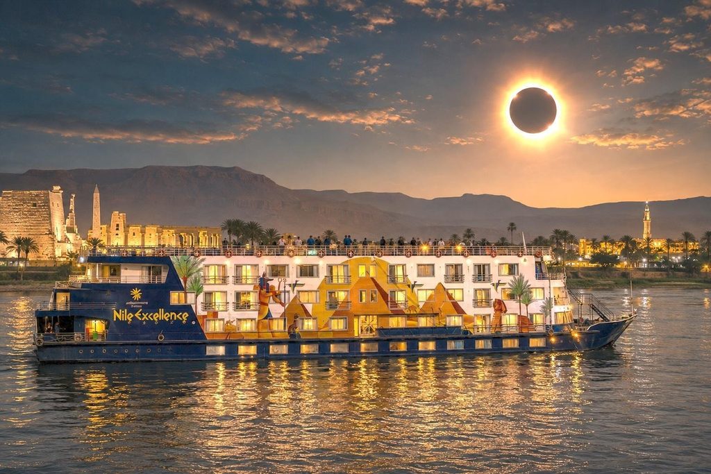 Nile Excellence river cruise ship sailing past ancient Egyptian ruins during a breathtaking total solar eclipse.