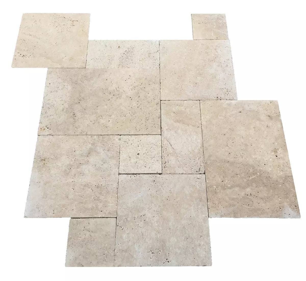Ivory-colored travertine tiles arranged in a geometric pattern. Various rectangular shapes create a harmonious, modern design with a natural stone texture.