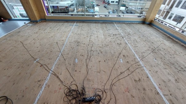 Experimental and numerical investigation of damping behavior in CLT floors under real building conditions