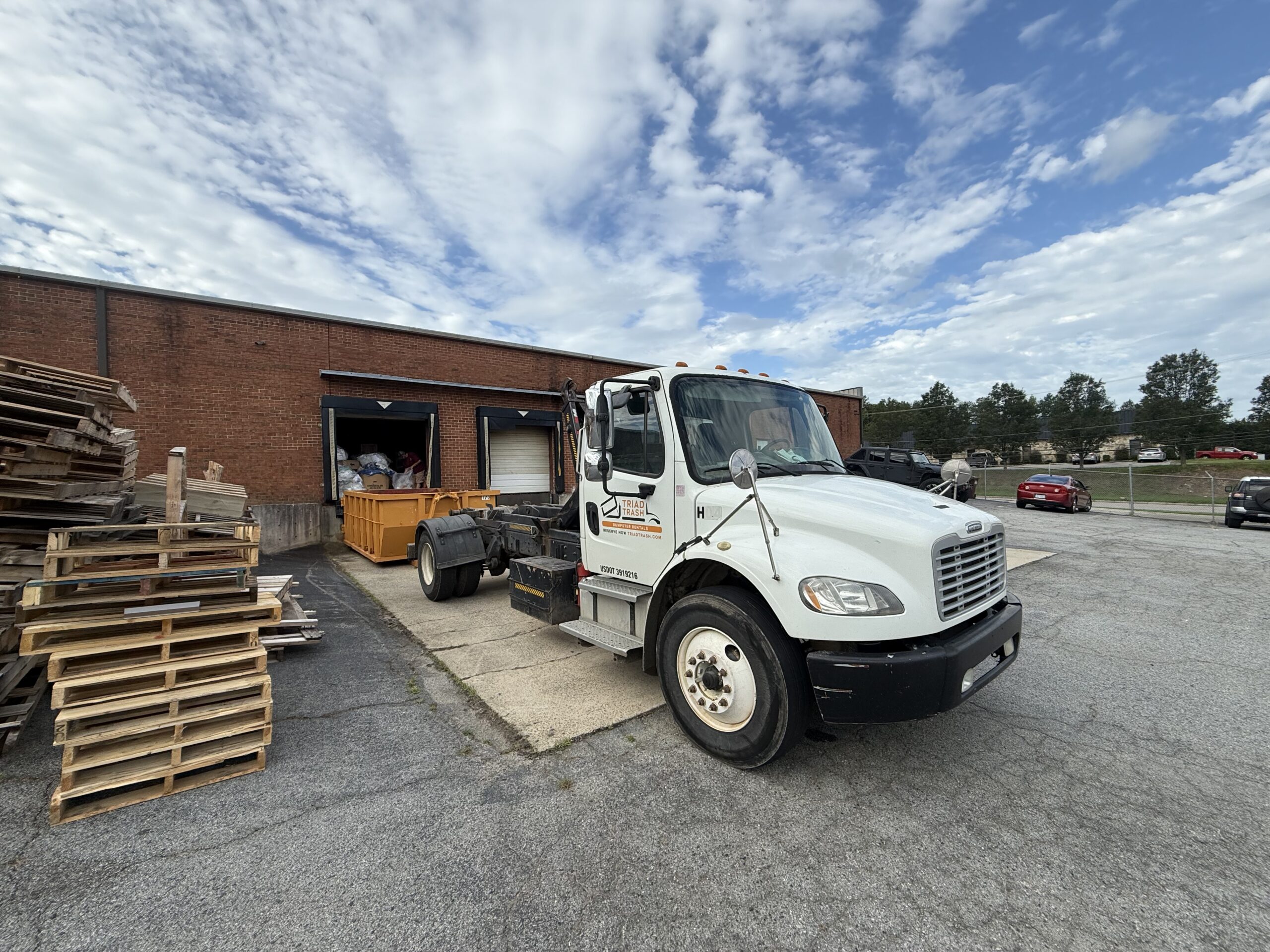 triad trash truck at warehouse customer