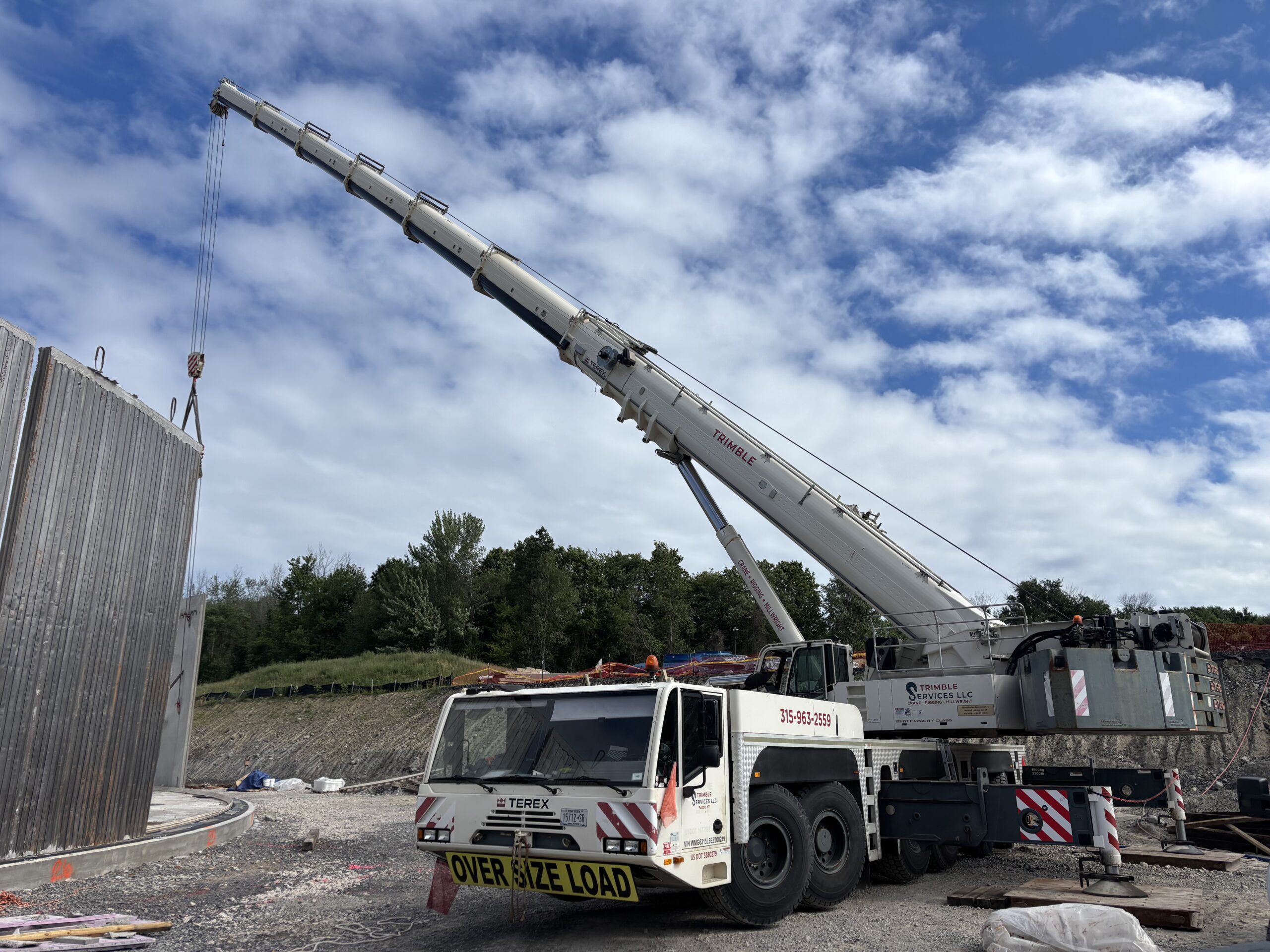 Trimble Services' 300-ton Terex Demag crane positioning a precast concrete wall panel during the OCWA water tank project.