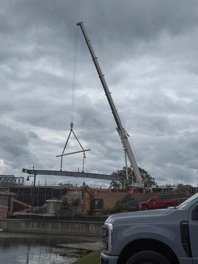 Trimble's 300 ton crane hoisting a 25,000 pound steel girder for the Brewerton Bridge girder installation