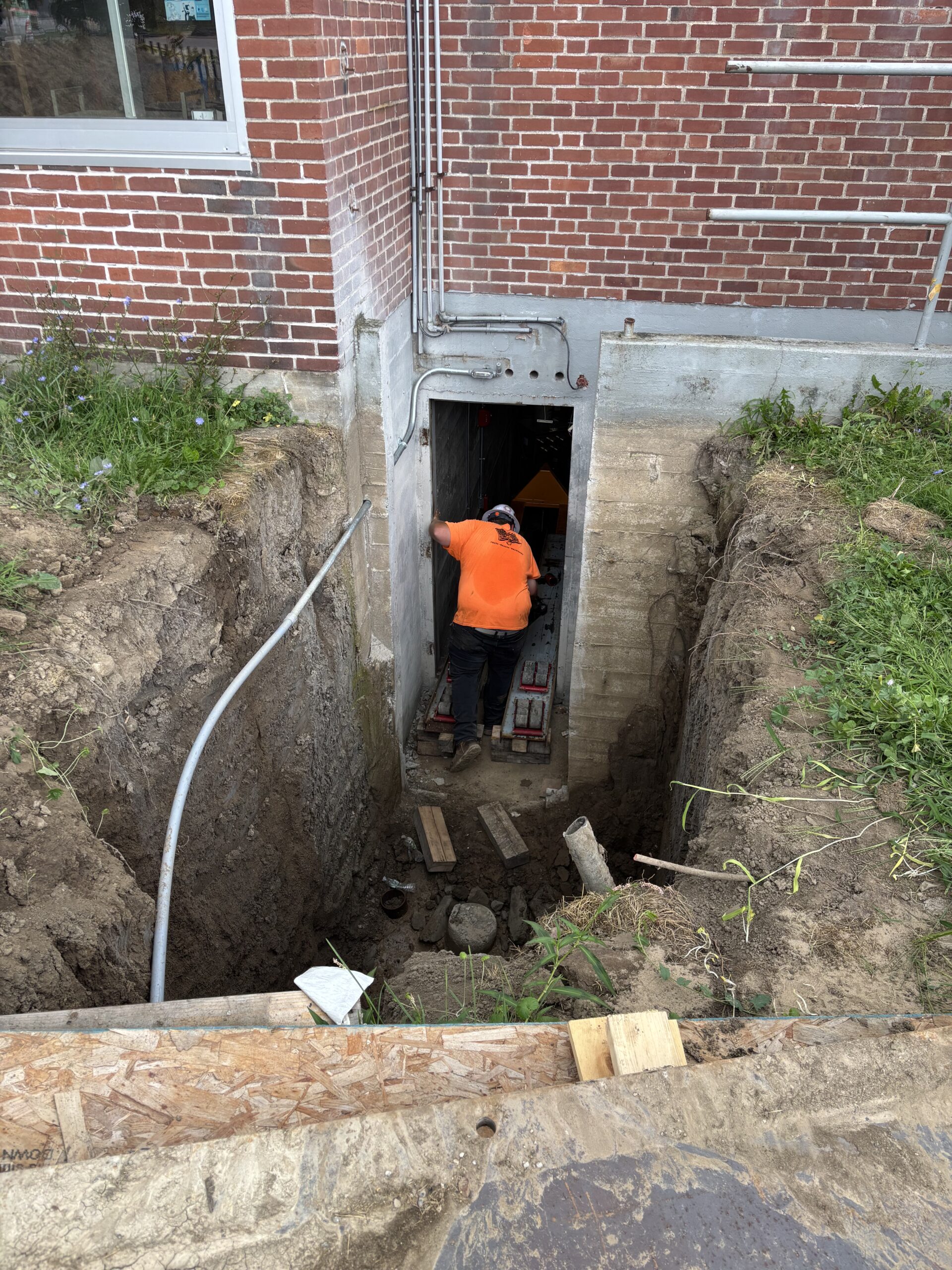 Excavated basement access at Starbuck Elementary during boiler installation in Watertown, NY.