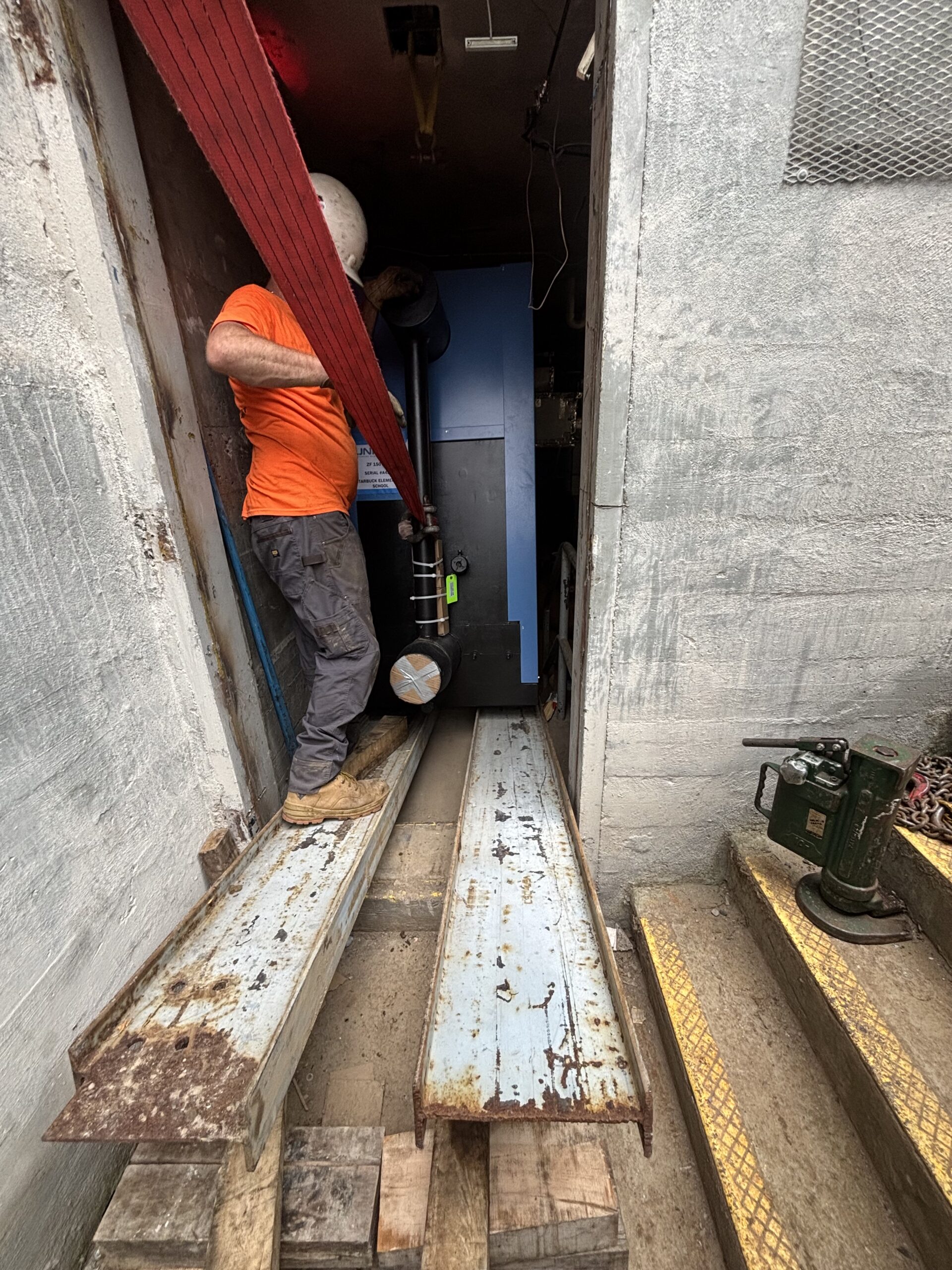 ,000-pound boiler positioned on a steel runway during installation at Starbuck Elementary in Watertown, NY.