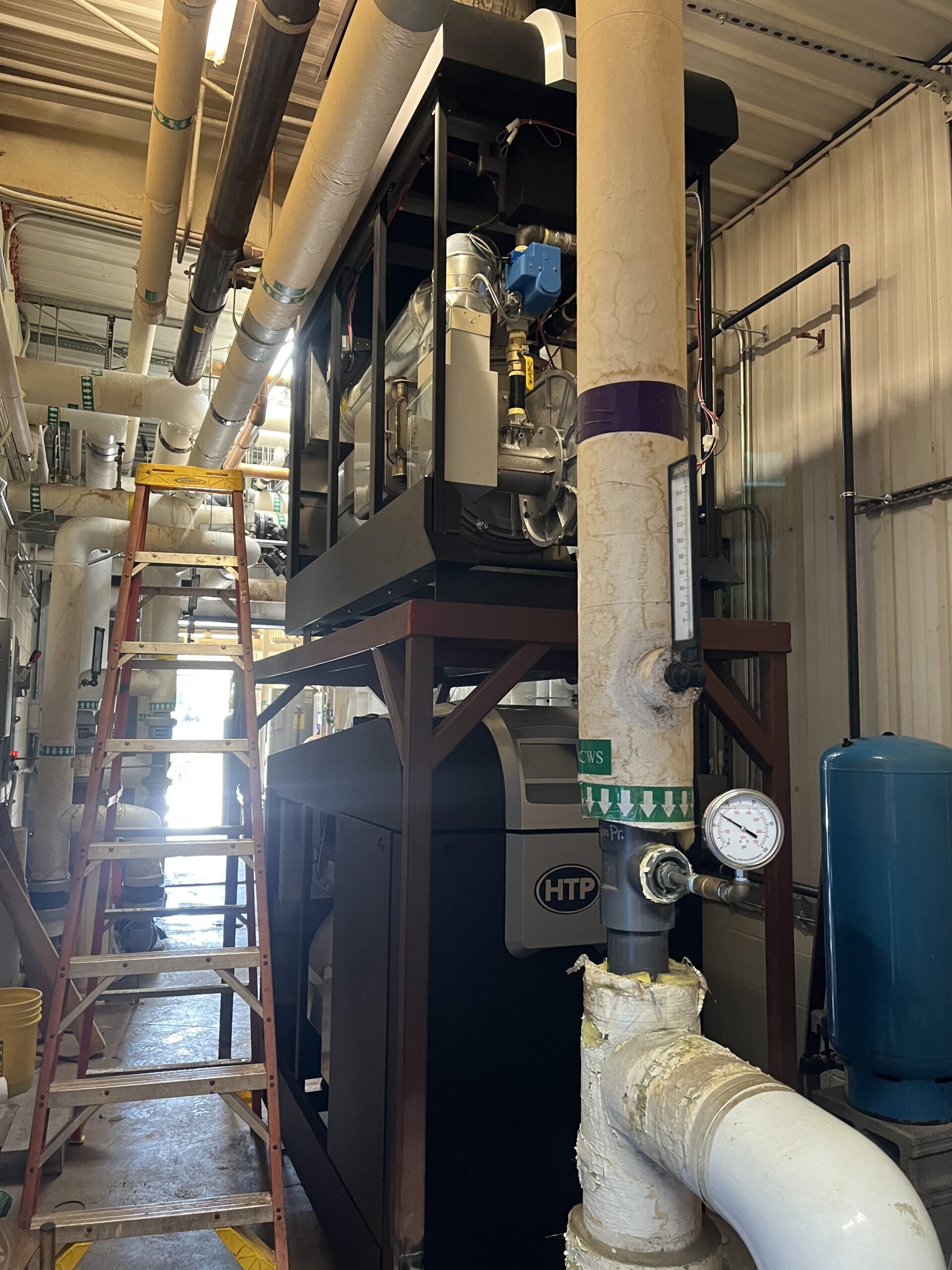 Boiler rigging in tight quarters around existing process piping at Aviagen