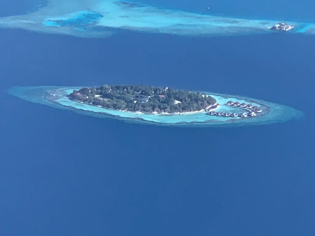 Aerial view of a Maldives island surrounded by turquoise water