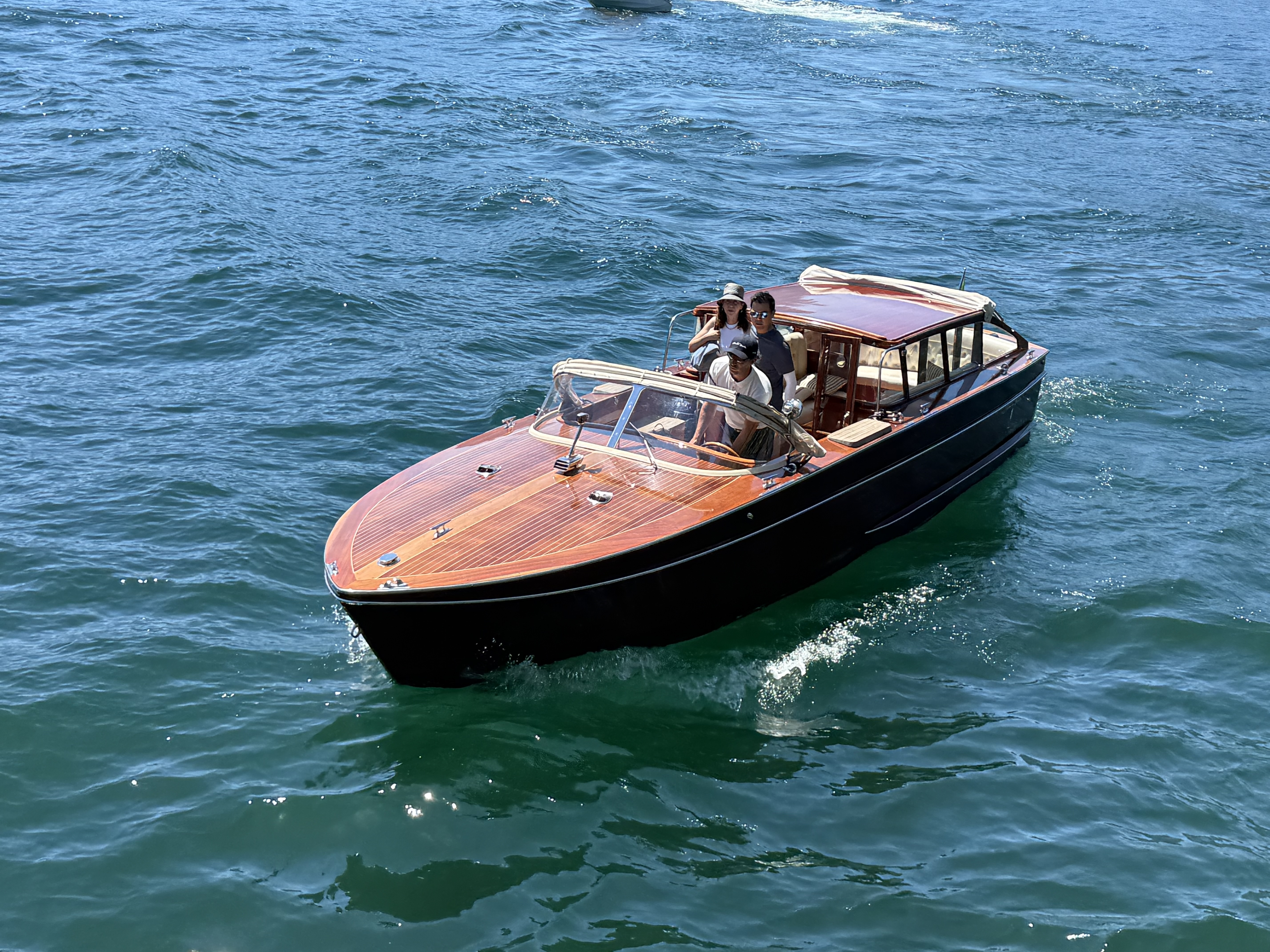Wooden motorboat crossing Lake Como