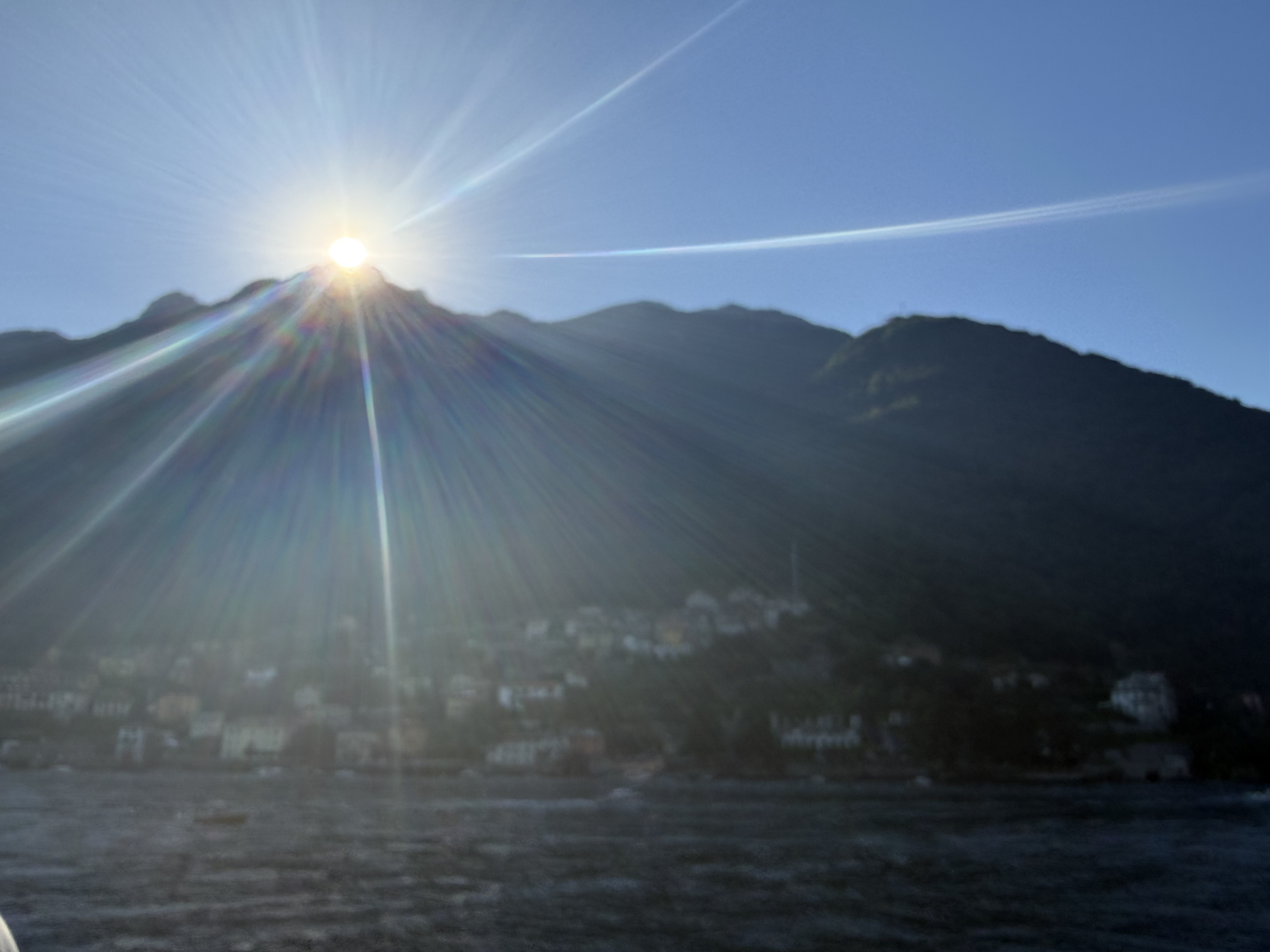 Sunlight over Lake Como and surrounding mountains