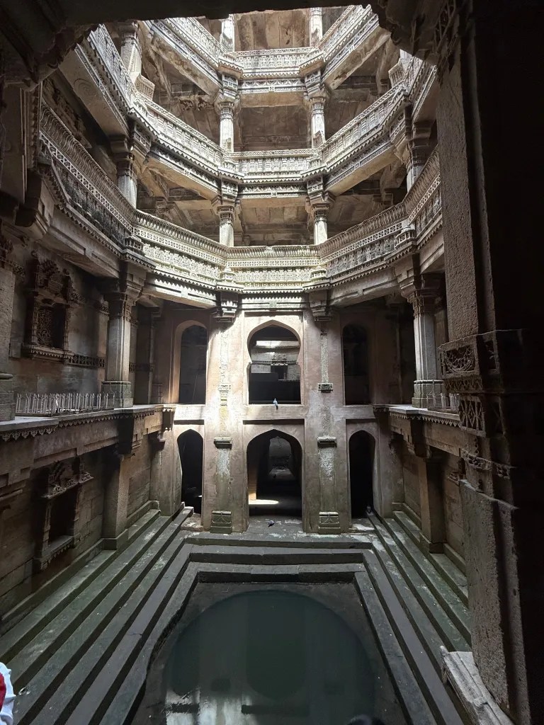 Carved galleries and descending steps inside a historic stepwell near Ahmedabad
