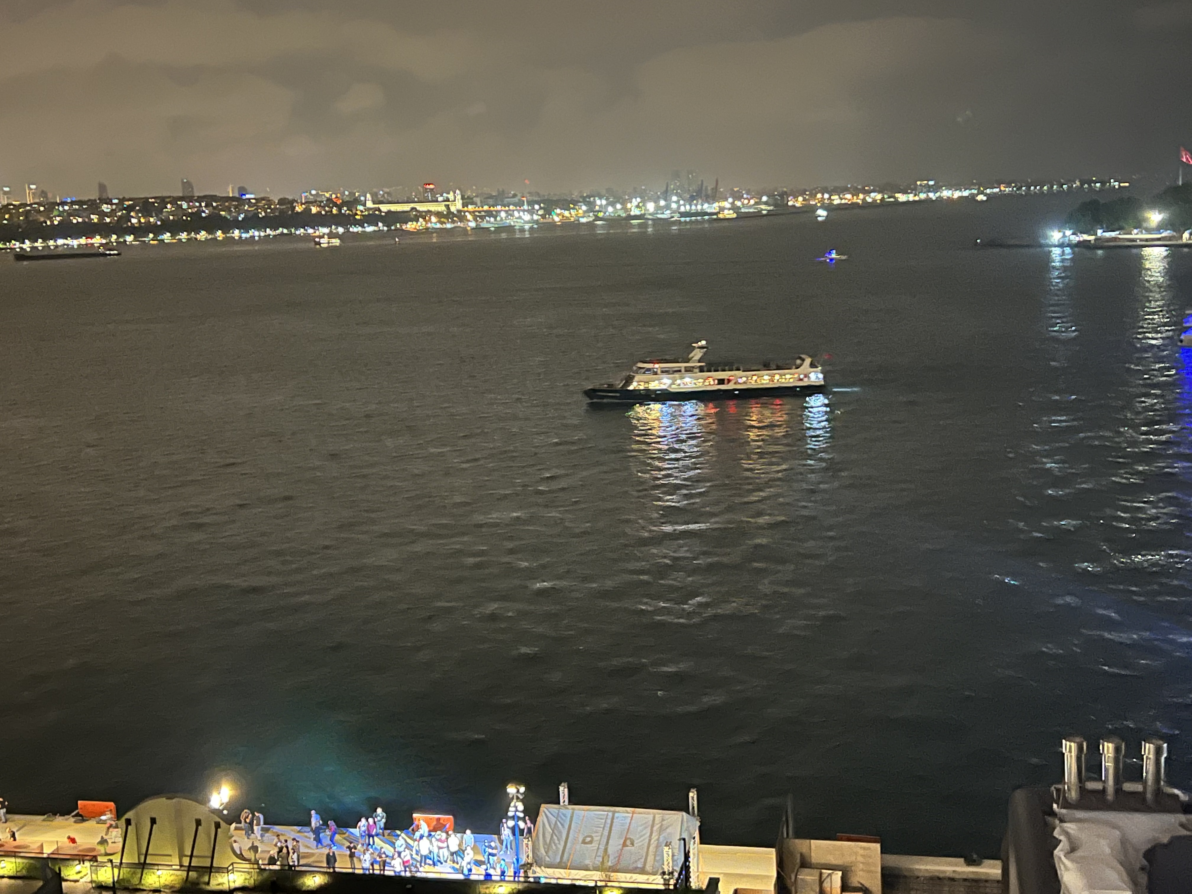Nighttime view across the Bosphorus with an illuminated ferry