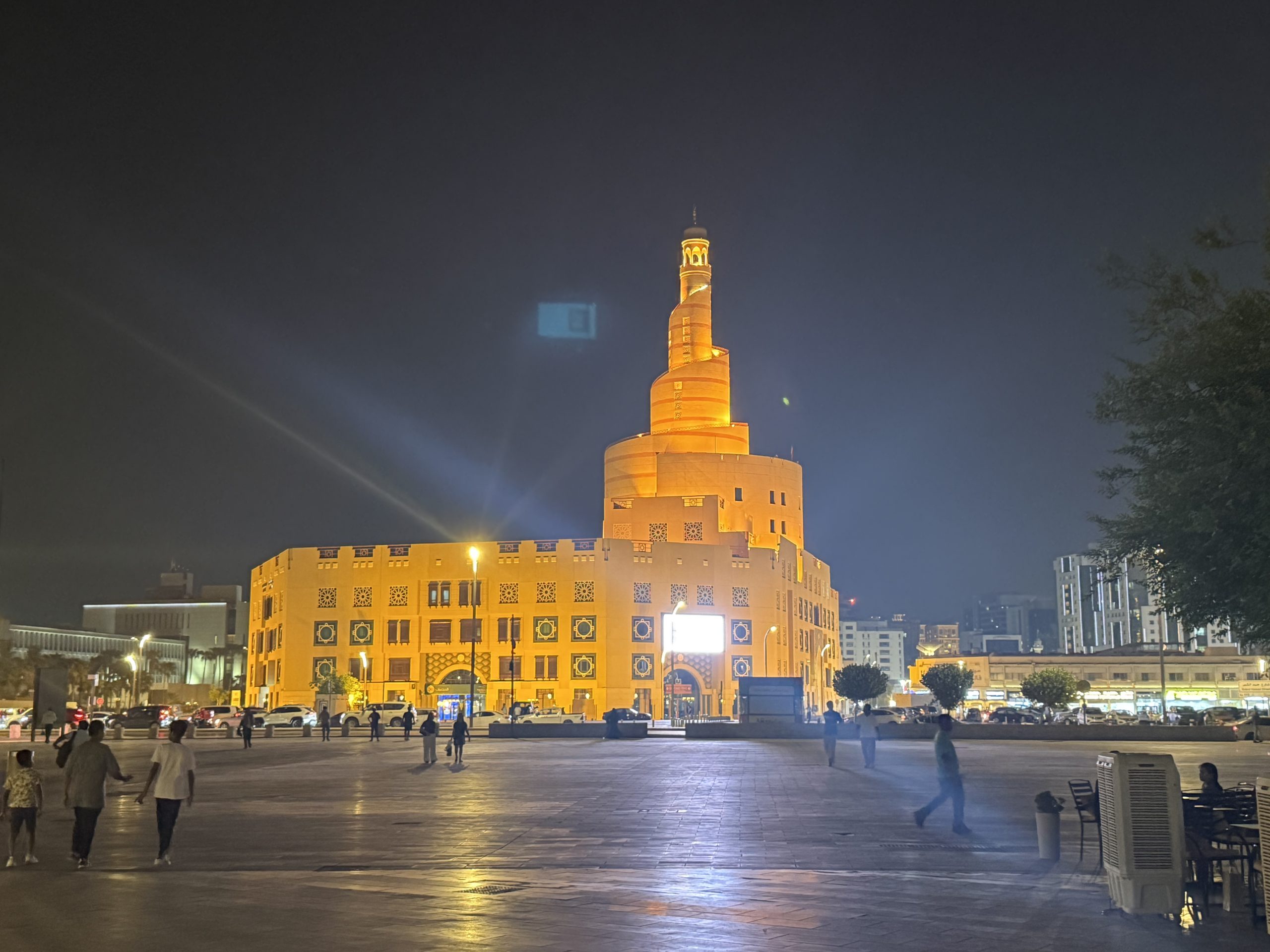 Illuminated tower and evening street scene in Doha