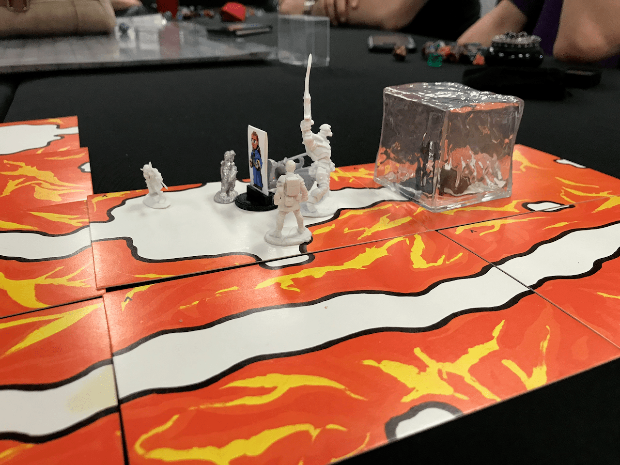 5e minis and a gelatinous cube mini on cavern tiles from The Sorcerer's Cave