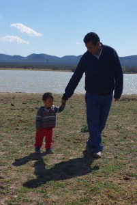 Pastor Rey and son walked beside the lake.