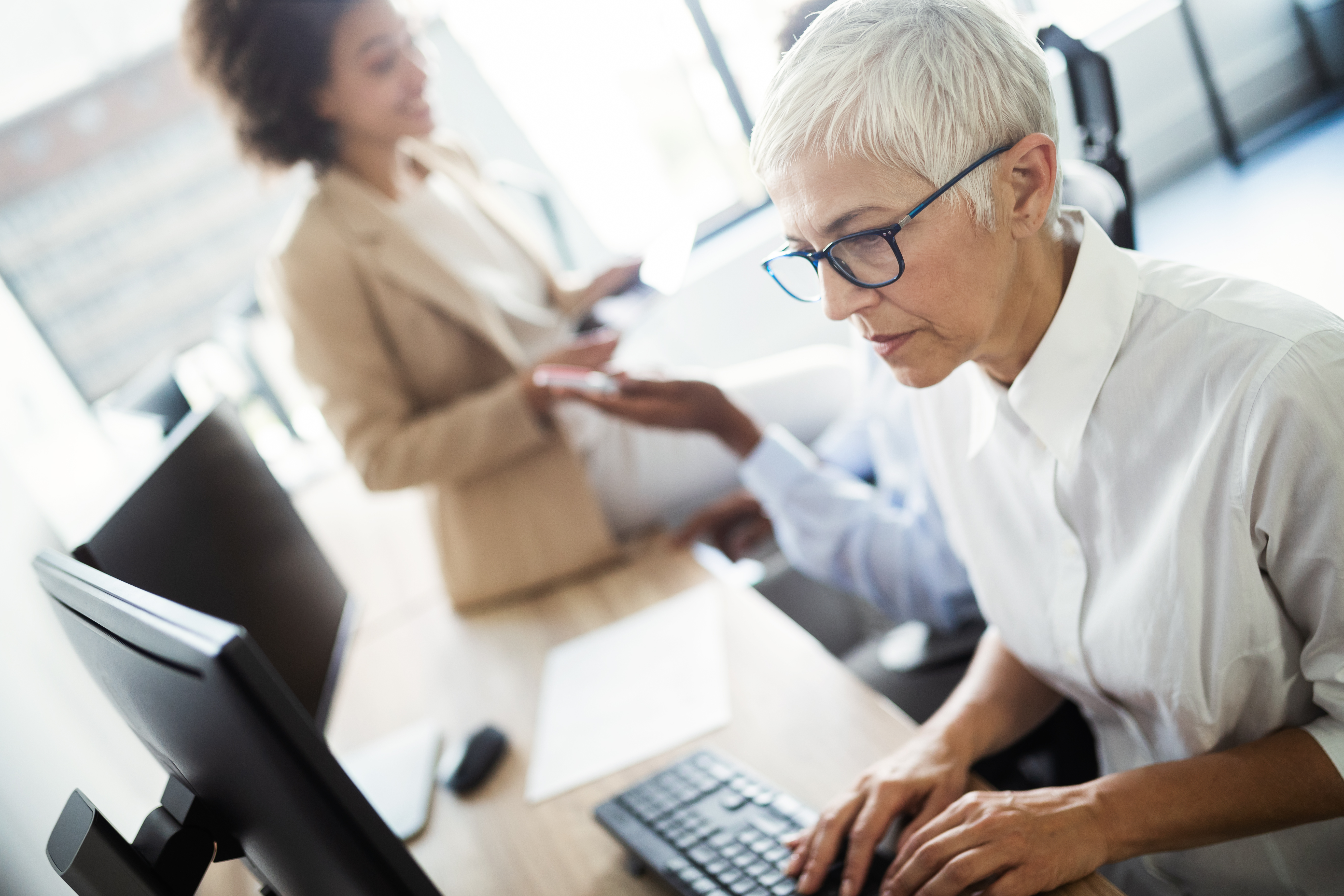 Programmers cooperating at modern IT company developing apps