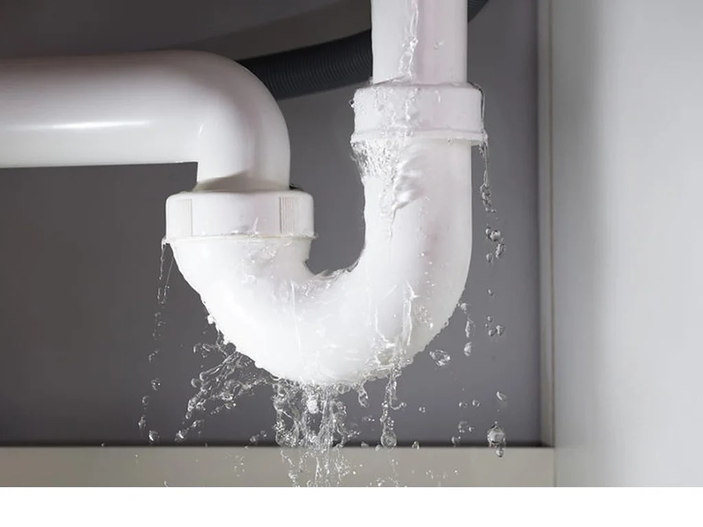 Emergency plumbing services fixing a leaking PVC P‑trap under a sink