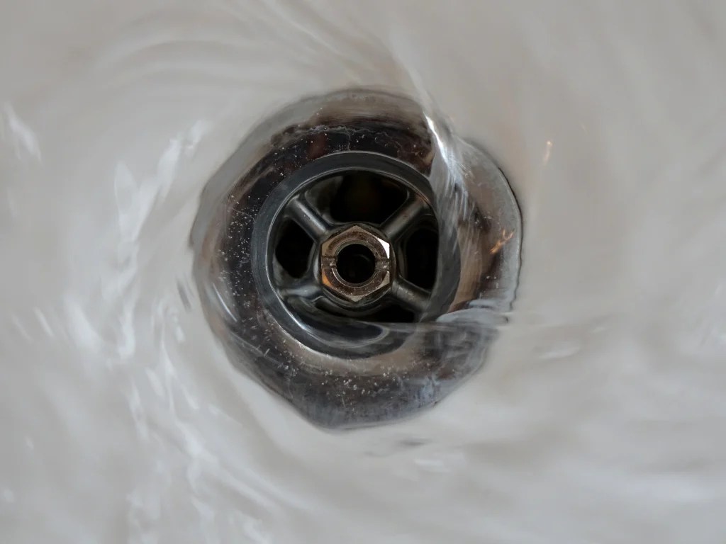 Sink drain swirling water needing 24 hour plumber near me for clogged drain
