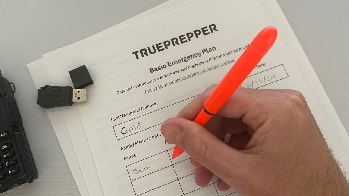 Sean filling out emergency plan template with orange pen.