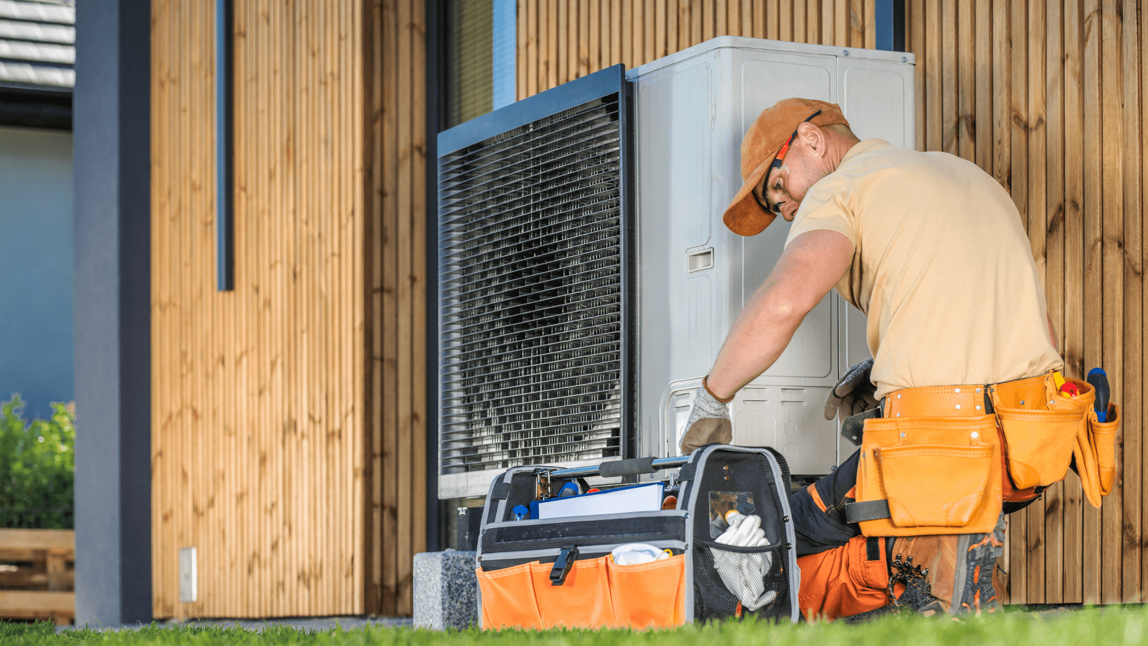 HVAC technician inspecting an outdoor heating and cooling system