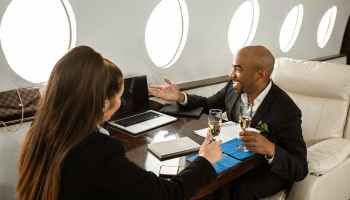business partners having a discussion on a private jet