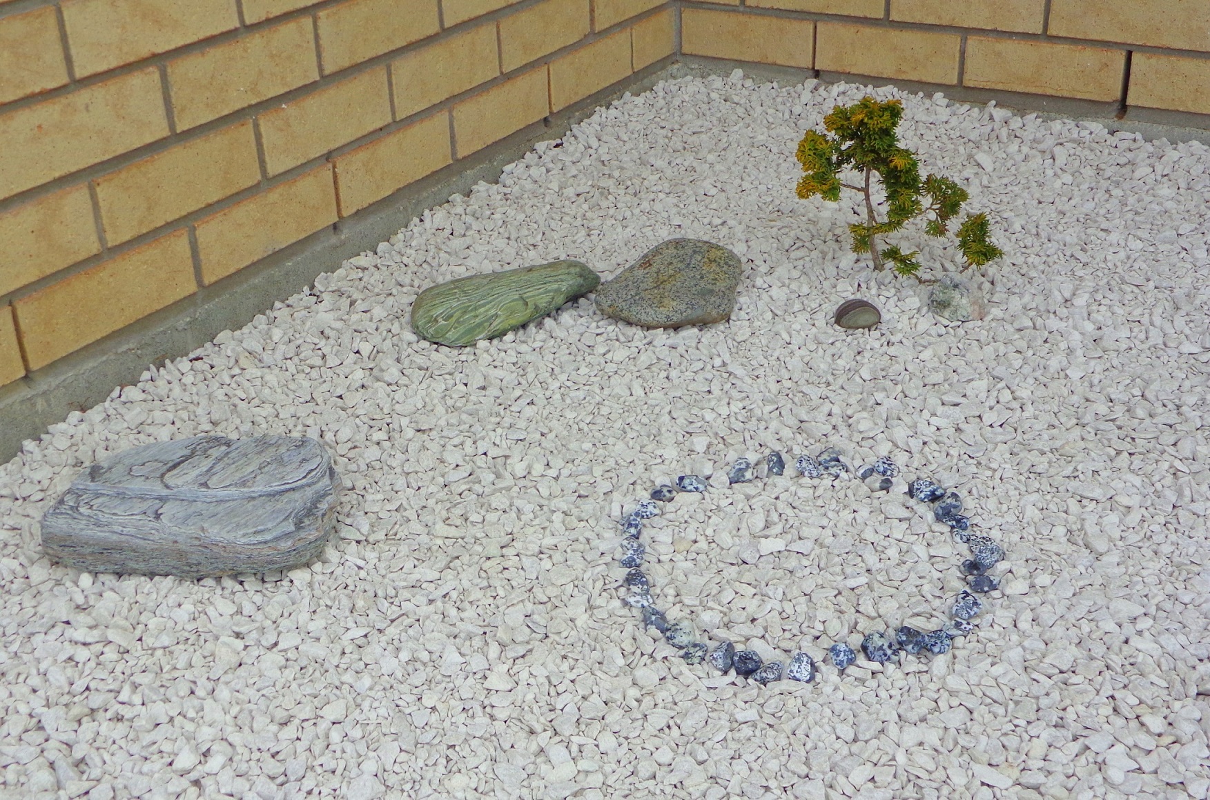 A sn=mall circle of semi-polished black and white stones collected from footpaths at Slope Point and Hendersons Bay in Southland