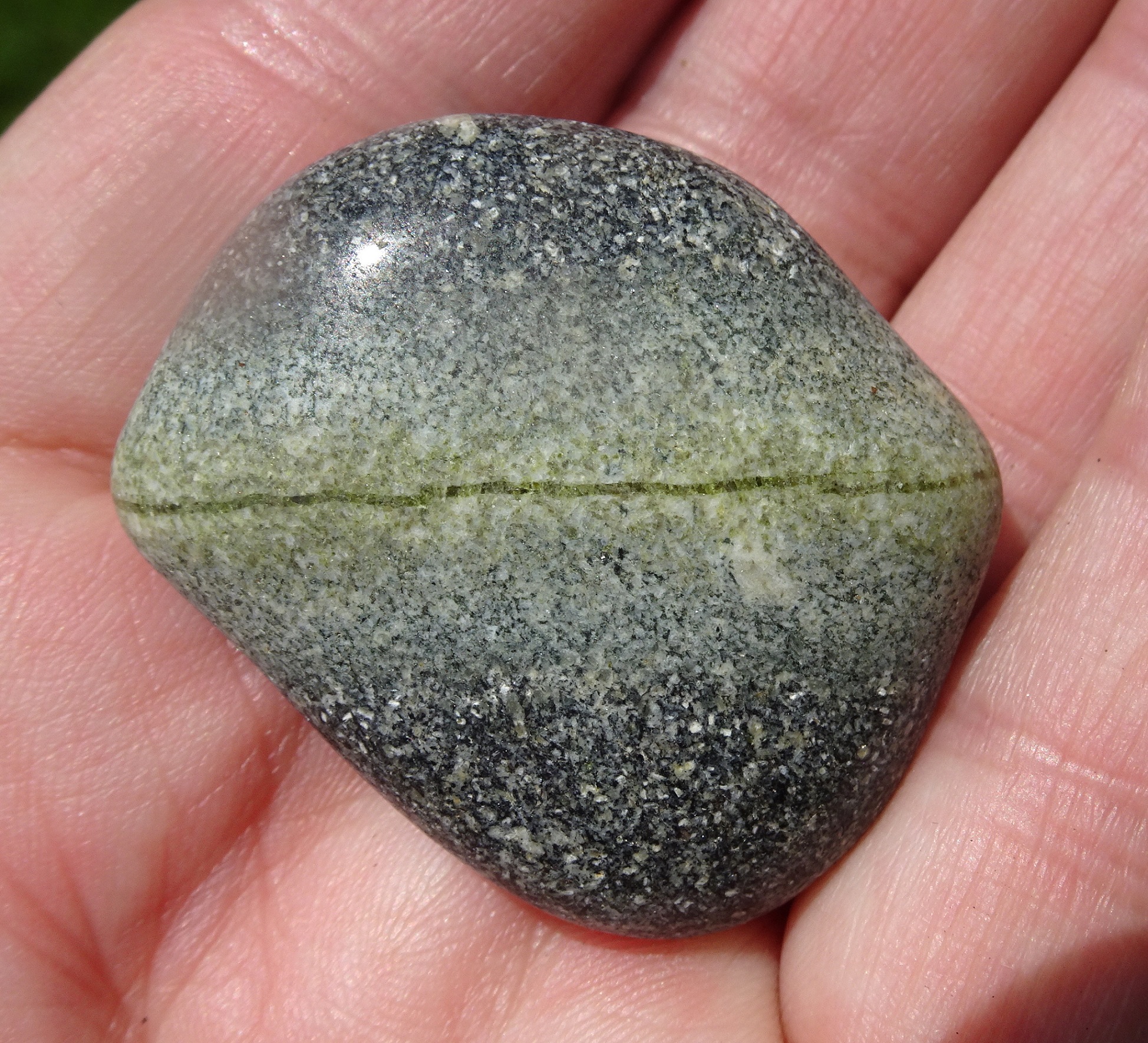 Fine green crystal band in the middle, more resistant to erosion.