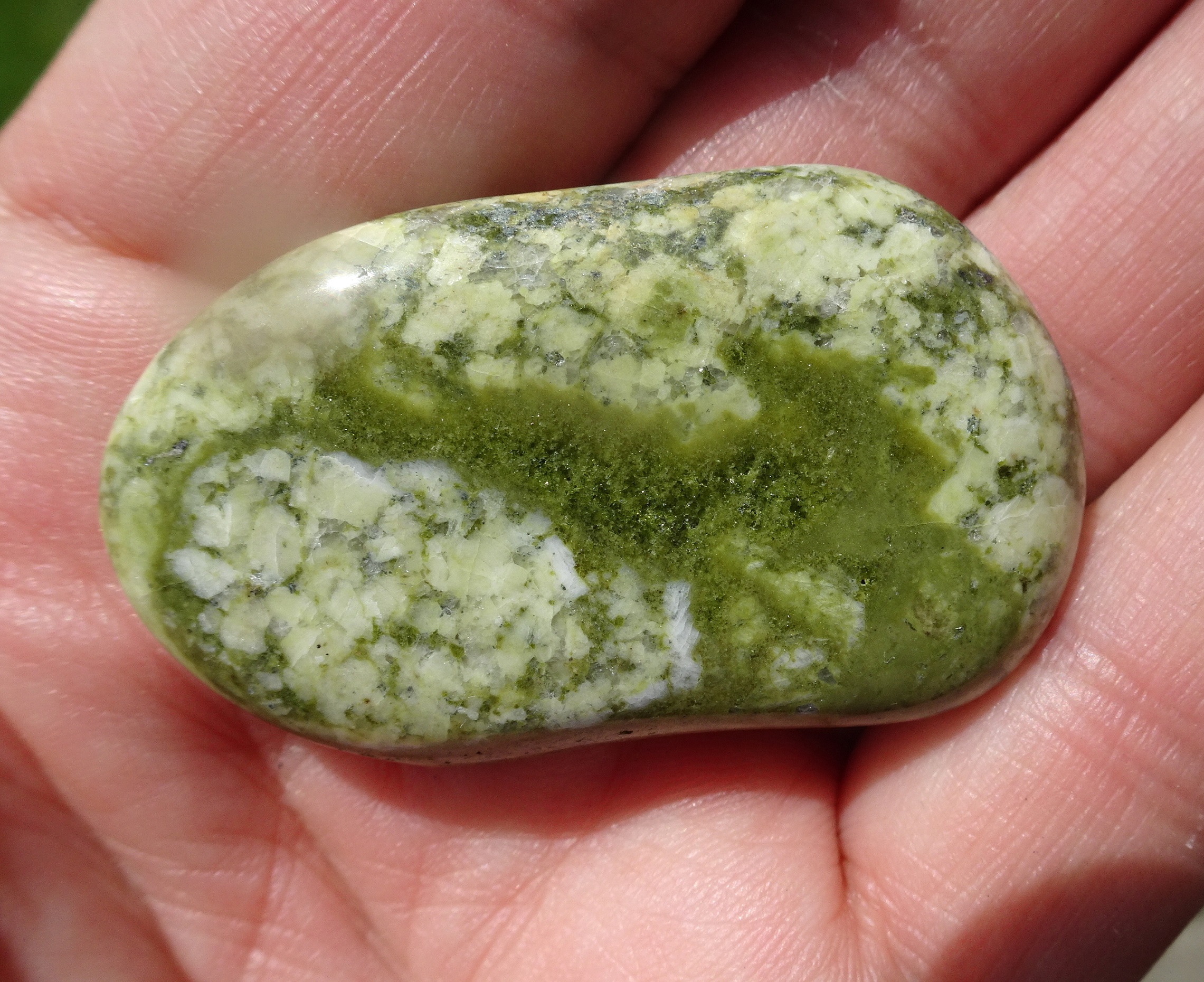Maybe more green than white, this stone has tiny sparking crystals within it.