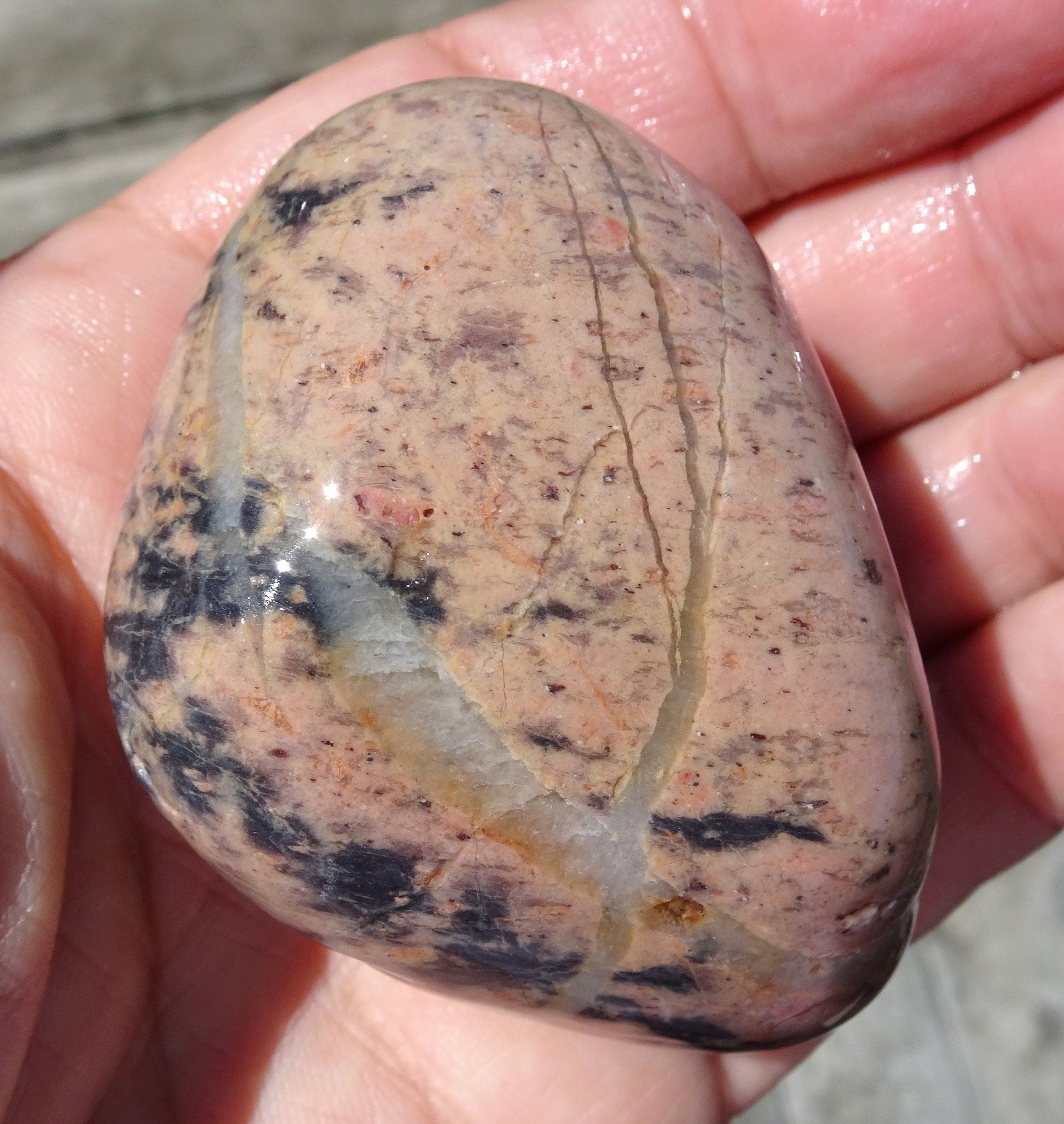 Pastel-coloured stone with interesting veins. Looks like rhodonite but unsure of this.