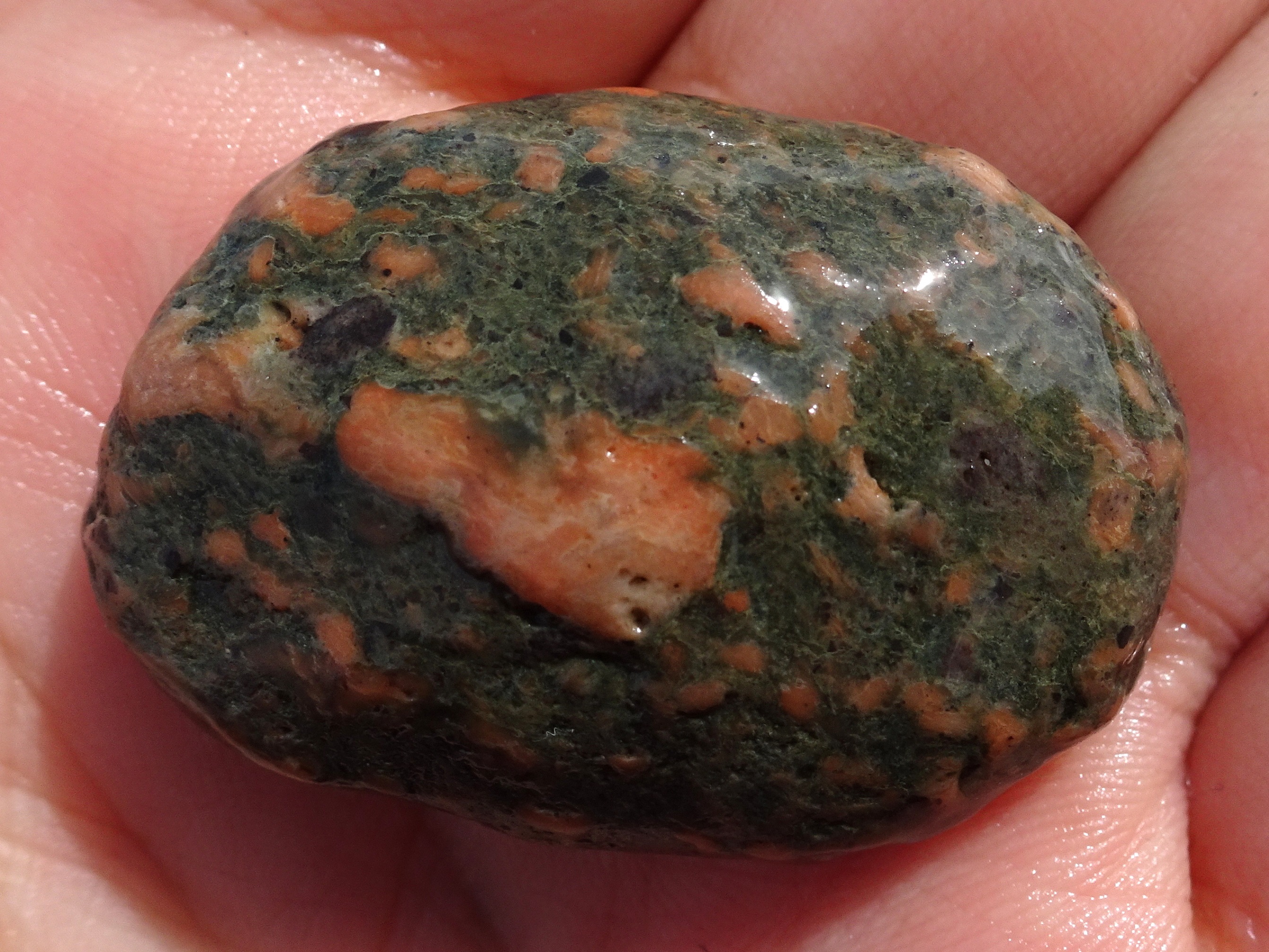Small stone, with raised colourful segments.