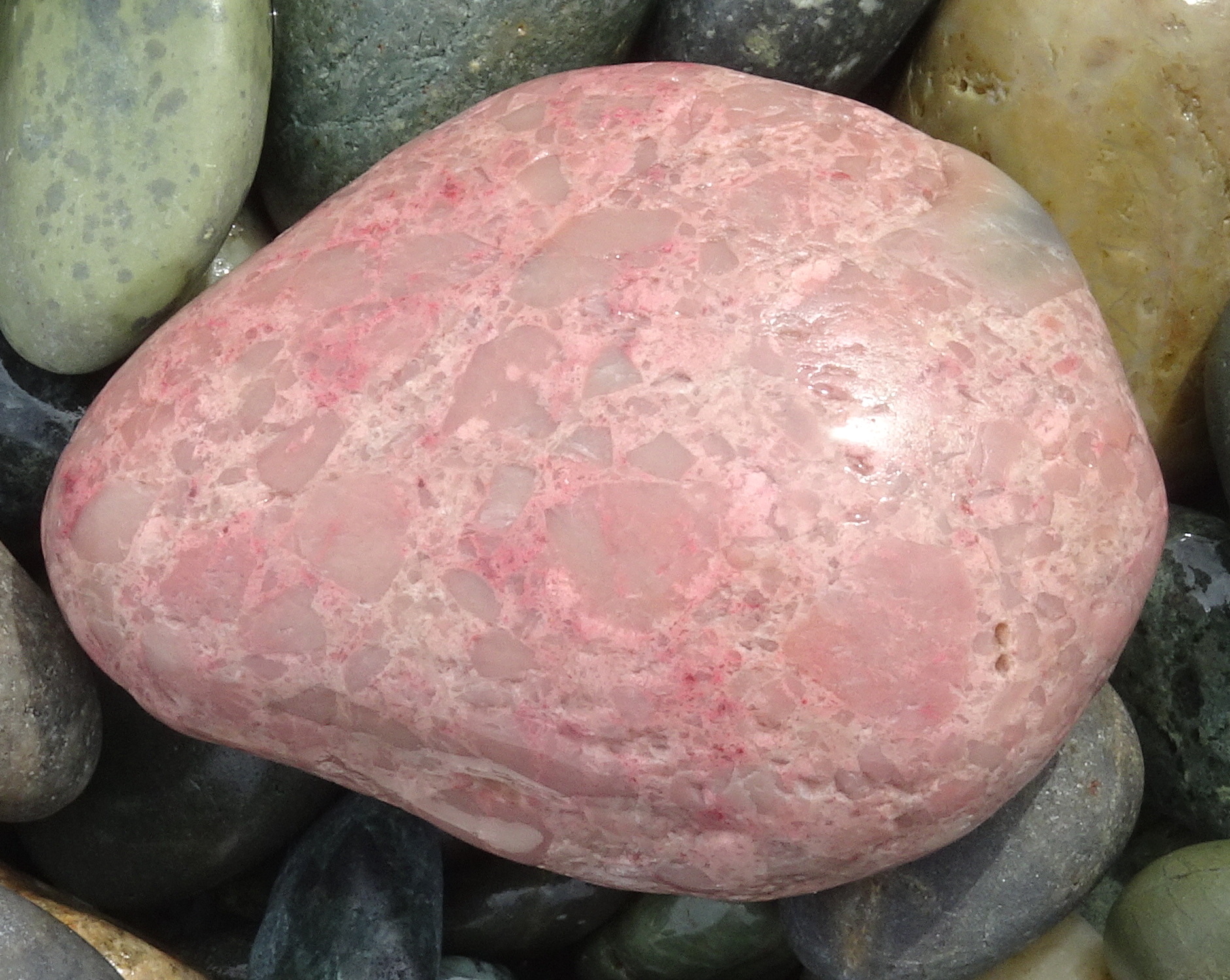 A large pink stone (thulite).