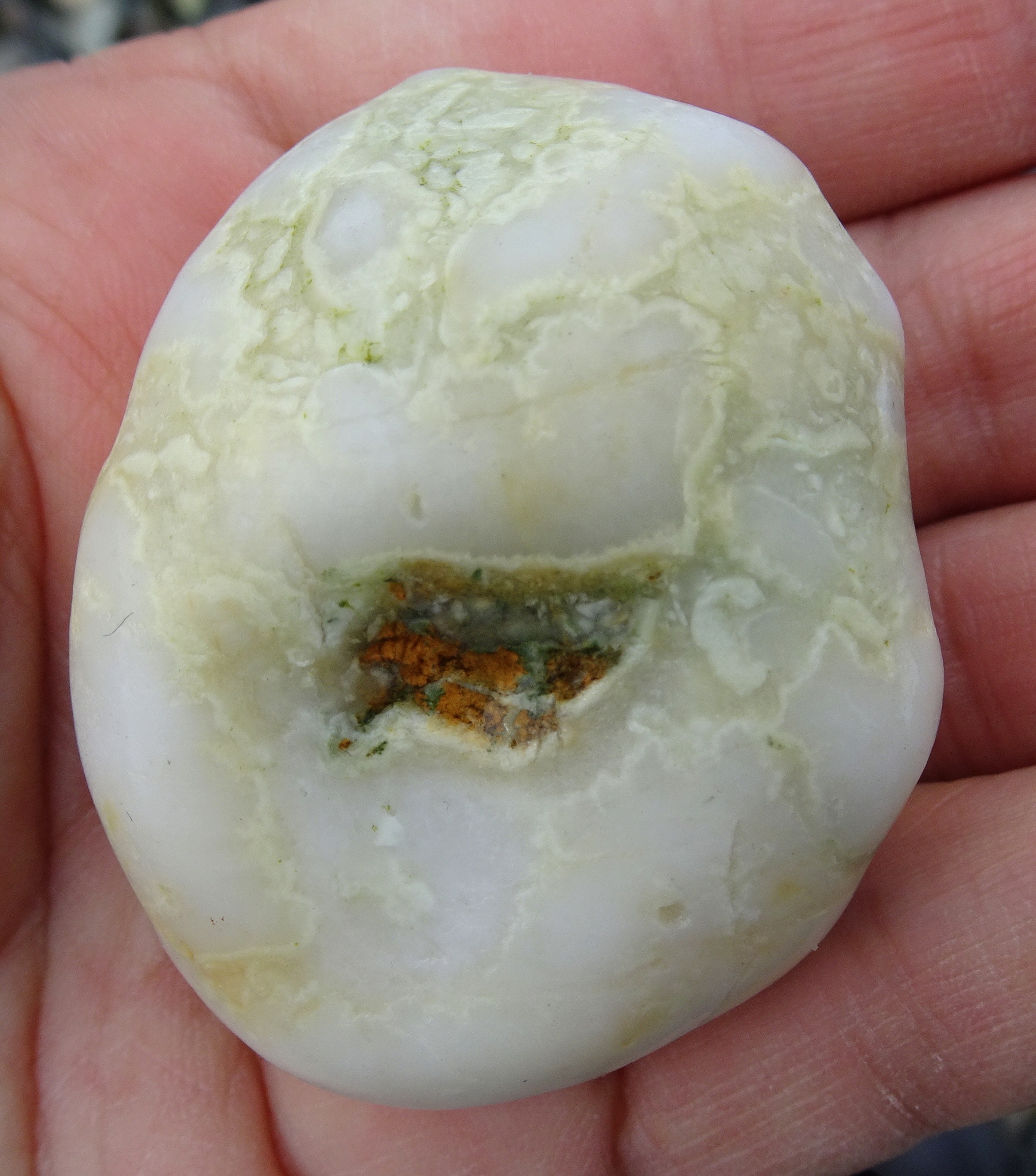 A white stone with an interesting middle and outer swirls.
