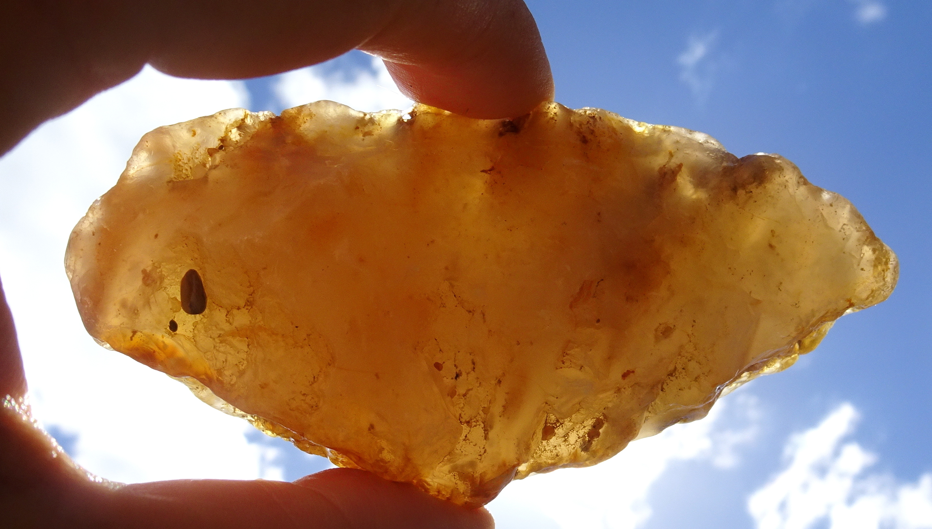 Seam chalcedony held up to sun.