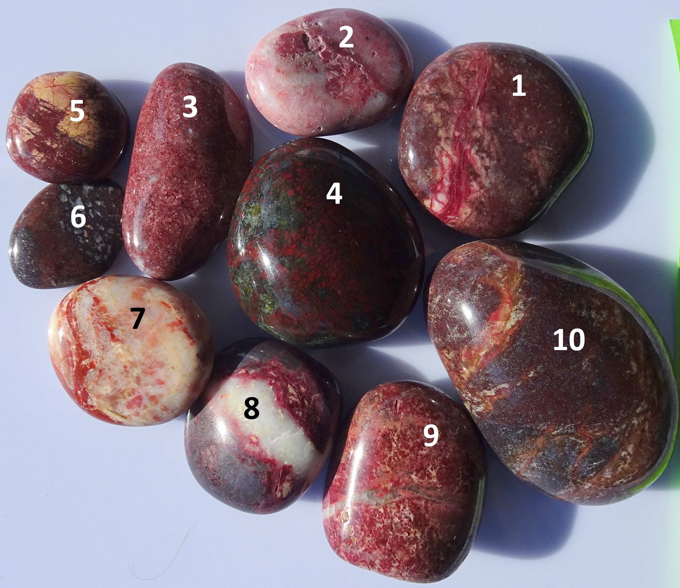 Ten polished purple stones from Gemstone Beach.