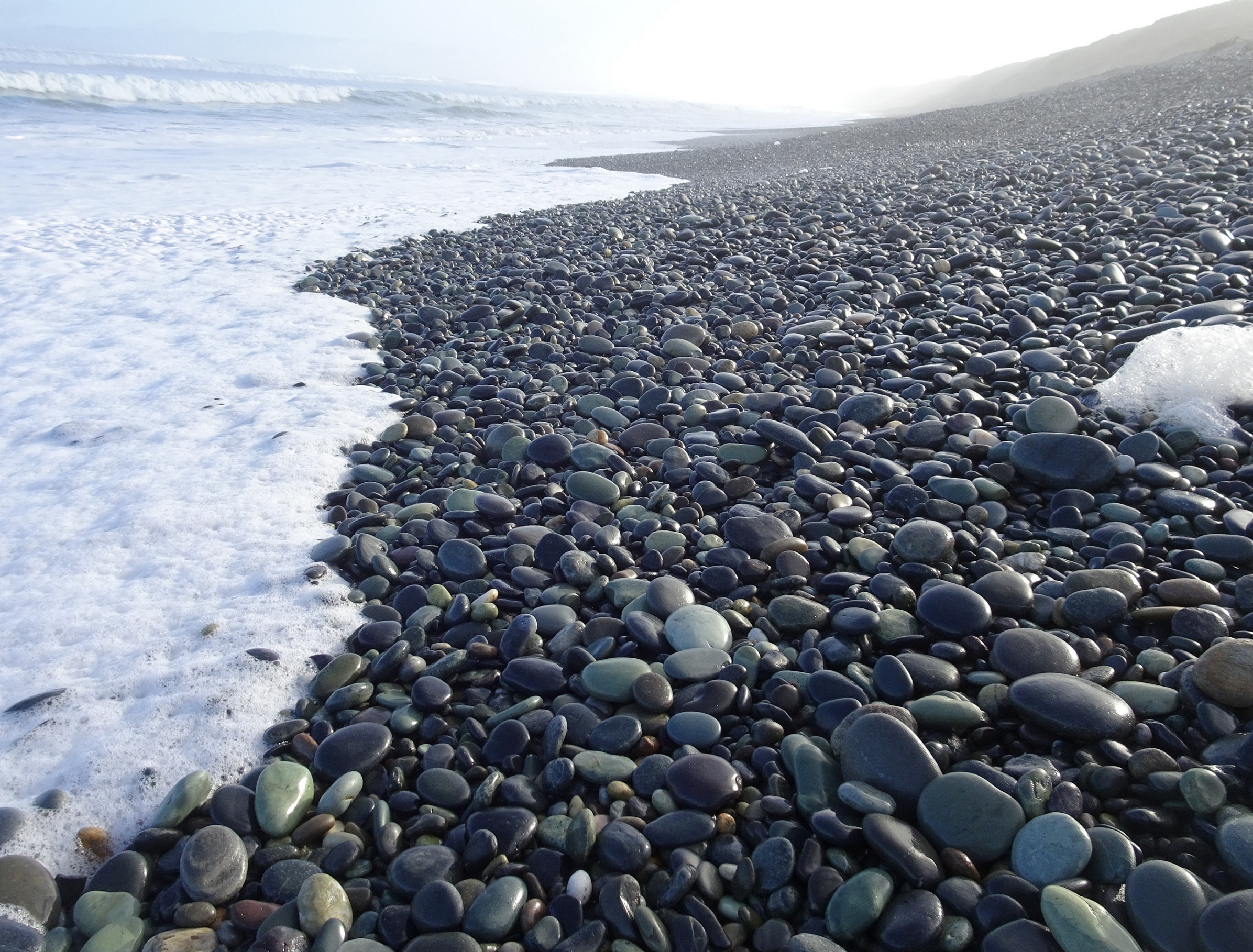 At the edge of the waves.