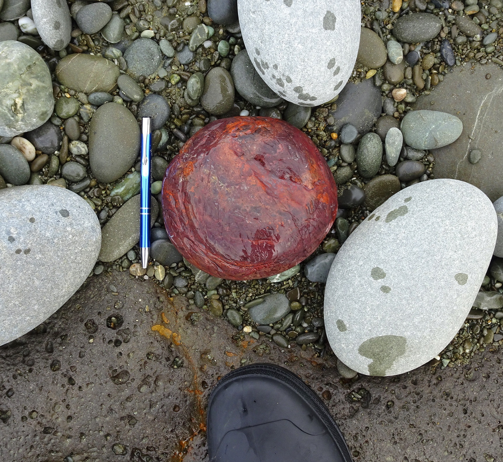 Large jasper, left on beach, just below the lighthouse. Pen and front of gumboot for scale.